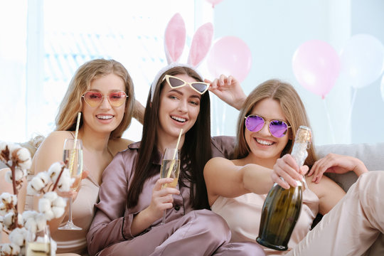 Beautiful young women drinking champagne at hen party