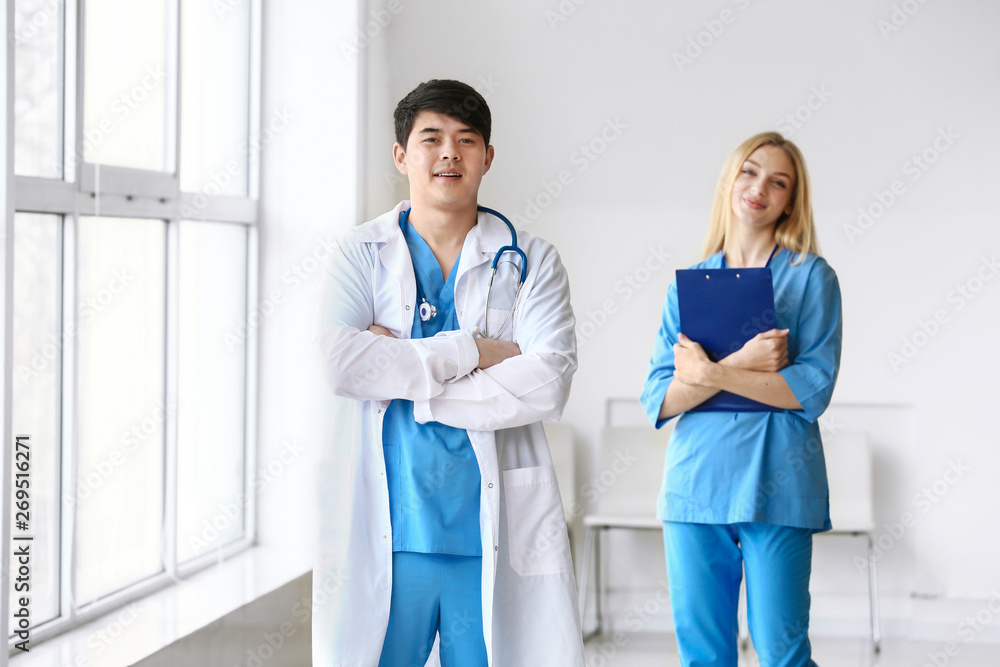 Canvas Prints Male doctor and female medical assistant in clinic