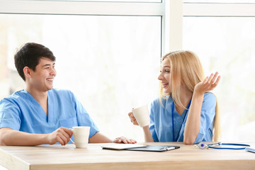 Young medical assistants having break during work in clinic