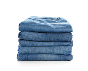 Stack of jeans pants on white background