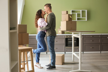 Adorable loving couple after moving into new house