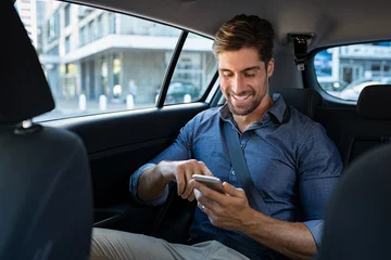 Foto op Plexiglas Happy business man in car using phone © Rido