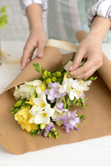 Obraz na płótnie Canvas Florist making beautiful bouquet in shop