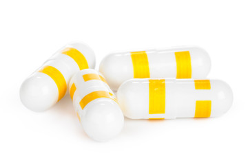 yellow vitamin pills isolated on white background