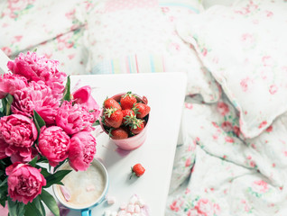 Delicate bouquet of peonies and strawberries. Atmosphere of rest and relaxation.