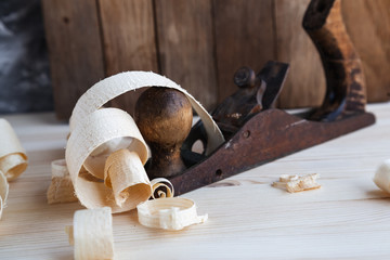 Wood planer in the carpentry workshop on wooden background.