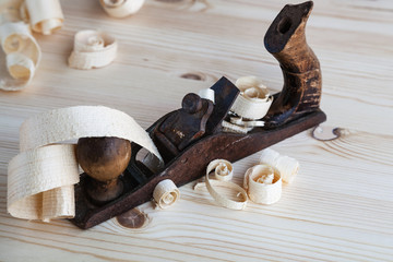 Wood planer in the carpentry workshop on wooden background.