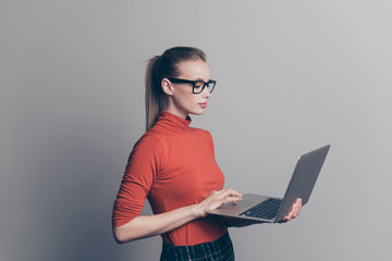 Profile side view portrait of her she nice lovely attractive professional intelligent girl eyewear holding in hand netbook writing new article story isolated over gray pastel background