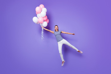 Fototapeta na wymiar Full length body size view portrait of her she nice attractive girlish crazy funny cheerful cheery girl having fun flying with helium balls isolated over violet purple vivid shine bright background