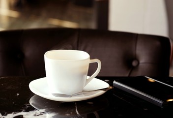 Hot coffee in a white ceramic mug for refreshing and preparing for a new day.