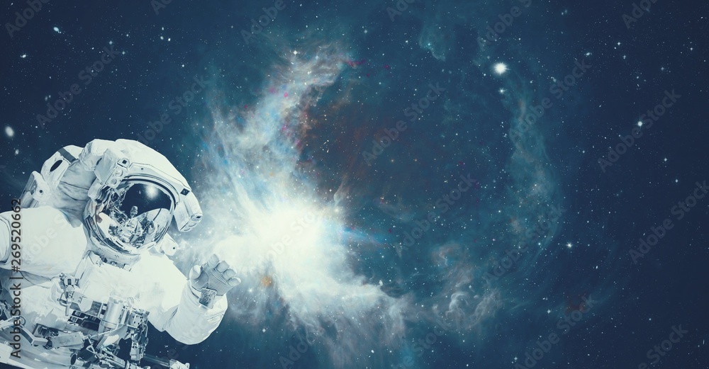 Wall mural astronaut in space suit in the outer space with the sunrise on planet and asteroids. elements of thi