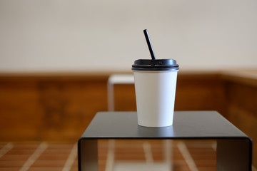 a cup of coffee. A glass is on the table in a cafe on Wooden table