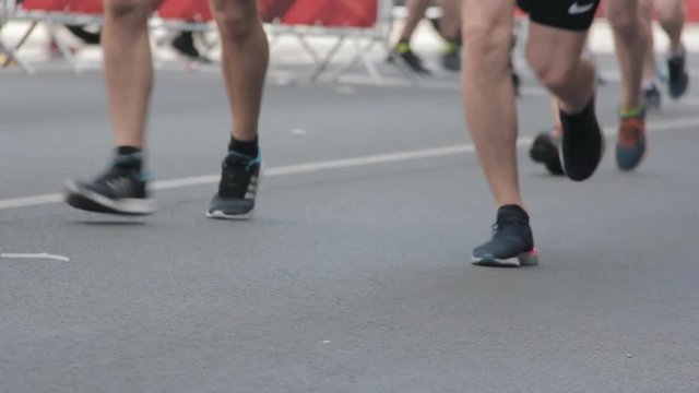 Marathon Runners Crowd Front  View Legs. Athletes Runing Out Off Focuss. Blurred Runner Feet Running Marathon.