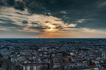 Berlin cityscape at sunset during a cloudy sky