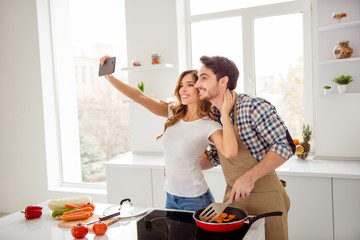Close up side profile photo two people beautiful he him his macho she her lady telephone hands make take selfies make first breakfast dishes bonding apartments flat bright white kitchen room indoors