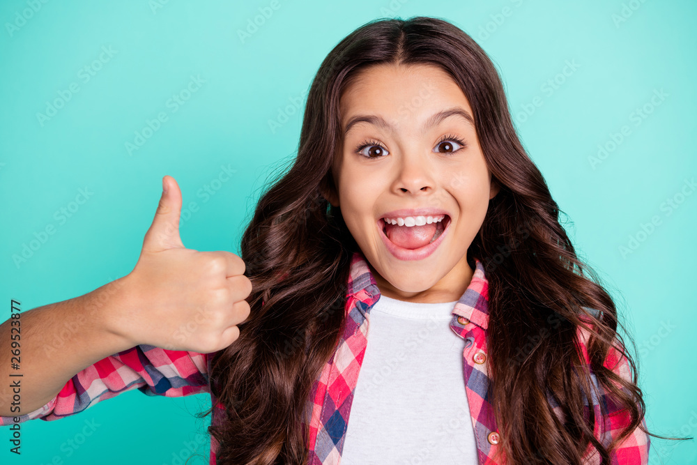 Sticker Portrait of trendy astonished kid impressed by incredible news ads choice decision recommend positive scream shout omg wow dressed checked shirt modern isolated green background