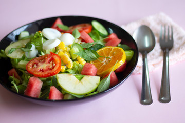 Selective focus Salmon Fresh green Salad with spinach, cherry tomatoes,baby spinach, Concept for a tasty and healthy meal. Dark stone background. Top view. Close up.