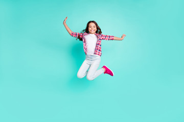 Fototapeta na wymiar Full length body size view photo lovely nice kid have funny funky enjoy content rejoice trip travel vacation trendy stylish move raise hands checkered clothing isolated turquoise background