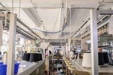 Fototapeta premium close up photo of black threads in cones on the knitting machines