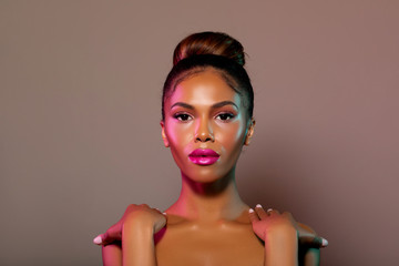Beauty portrait fashion girl with color lighting filters. Beauty girl face close up. Closeup African American woman with copy space. neon light blue and pink color. - image