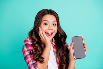 Close-up portrait of her she nice cute attractive cheerful cheery amazed wavy-haired girl in checked shirt holding hand new cool device isolated on bright vivid shine green blue turquoise background