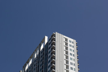 Obraz premium Oily gray tower on blue sky 