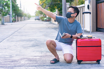 Man holding Red luggage with passport on blurred city background for activity lifestyle outdoors freedom or travel tourism andinspiration backpacker alone tourist image