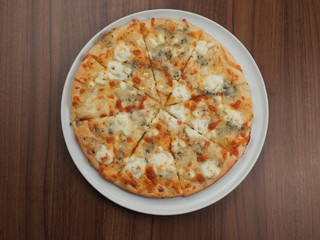 Pizza with cheese in a plate