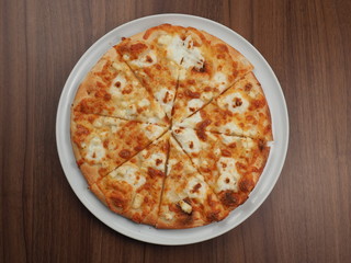 Pizza with cheese in a plate