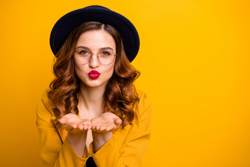 Close-up portrait of her she nice charming cute attractive lovely lovable sweet chic positive wavy-haired lady wearing yellow blazer sending kiss isolated on bright vivid shine orange background