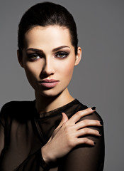 Face of a beautiful girl with fashion makeup and black nails