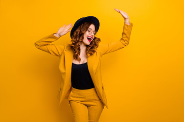 Portrait of her she nice charming cute attractive lovely fascinating fashionable chic cheerful wavy-haired lady wearing yellow suit jacket isolated on bright vivid shine orange background