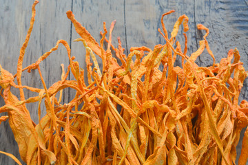 dried cordyceps militaris mushroom flower on wooden background. 