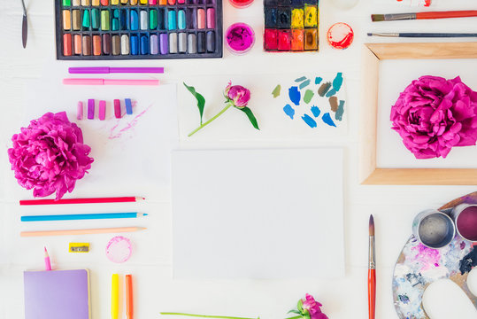 Topview workplace of creative artist mockup. Blank canvas with drawing materials and peony flowers on white background. Workshop, painting, drawing, inspiration, craft, creativity concept. Art therapy