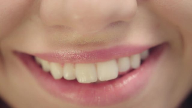Smiling female mouth with white teeth. Closeup woman face with perfect smile