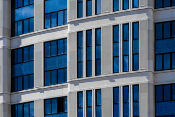 Part of modern office building with blue windows closeup. European architecture example