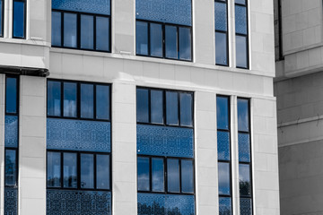 Part of facade of european building with blue windows close up. European architecture example