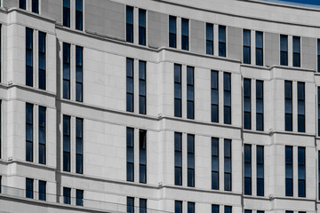 Part of facade of european building with blue windows close up. European architecture example