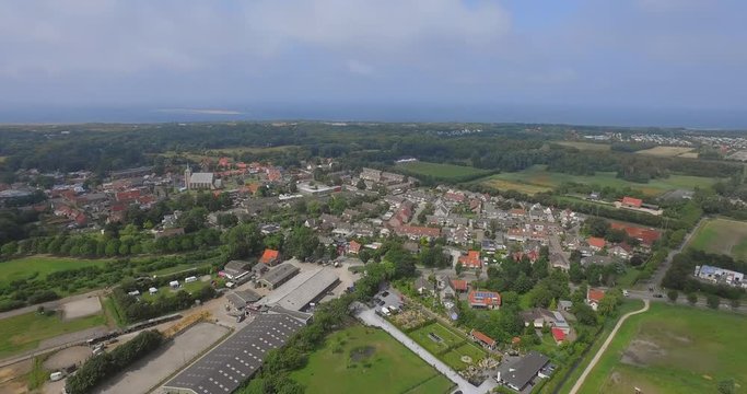 The small touristic town Renesse in the Netherlands during a light overcast day in summer. Aerial shot.