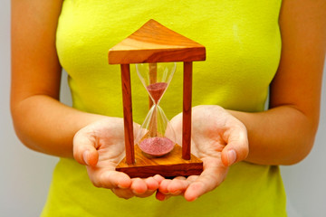 Holding an hourglass,