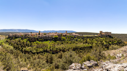Fototapeta premium Pedraza, Castilla Y Leon, Spain: panorama of Pedraza village from Mirador the Tungueras, with the Sierra de Guadarrama behind. Pedraza is one of the best preserved medieval villages of Spain