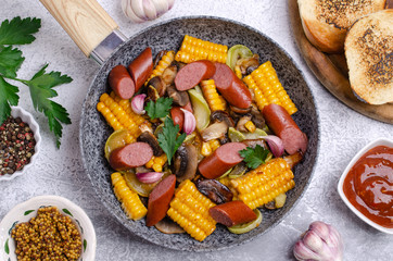 Slices of fried vegetables with sausages