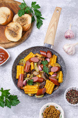 Slices of fried vegetables with sausages