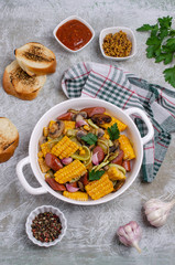 Slices of fried vegetables with sausages