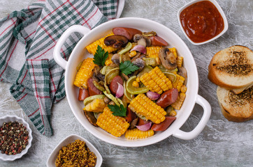 Slices of fried vegetables with sausages