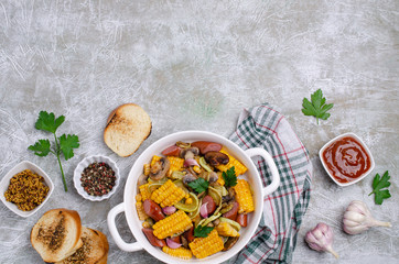 Slices of fried vegetables with sausages