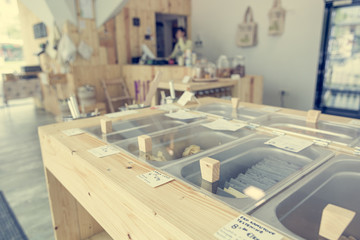 Different organic pasta in metal bowls ready for bulk shopping in zero waste store.
