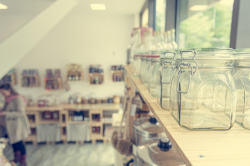 Closeup of empty glass jar in a zero waste shop.