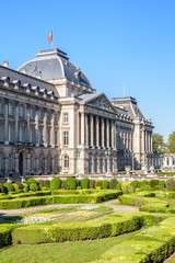Fototapeta na wymiar Three-quarter view of the colonnade and formal garden of the Royal Palace of Brussels, the official palace of the King and Queen of the Belgians in the historic center of Brussels, Belgium.