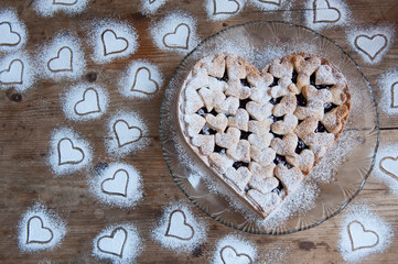 Cherry pie with heart shaped on the rustic background